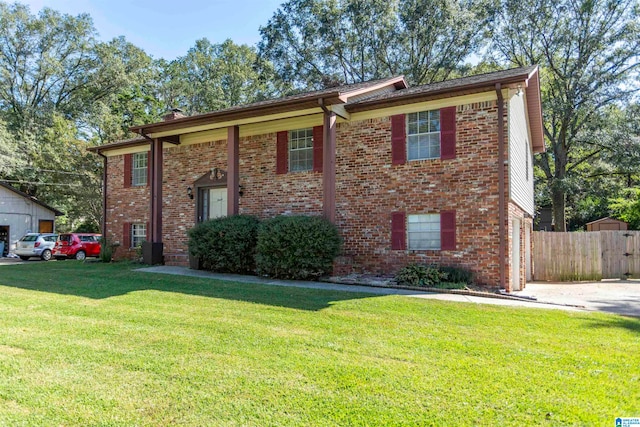 bi-level home with a front lawn