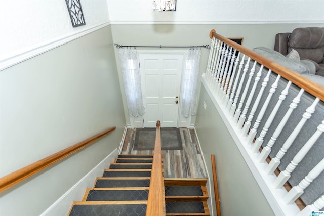 staircase with hardwood / wood-style flooring