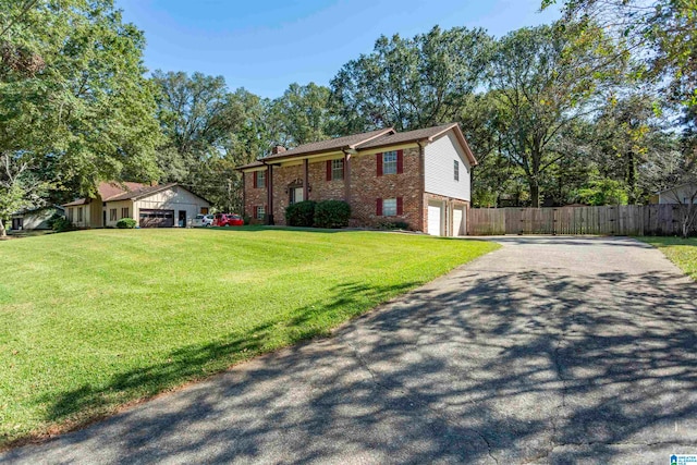 view of front of house featuring a front yard and a garage