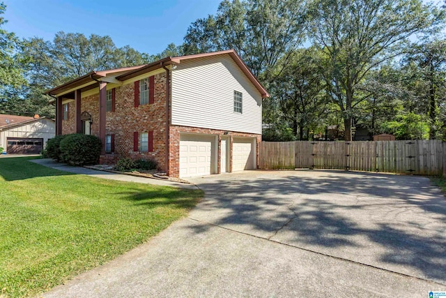 view of side of home with a yard and a garage