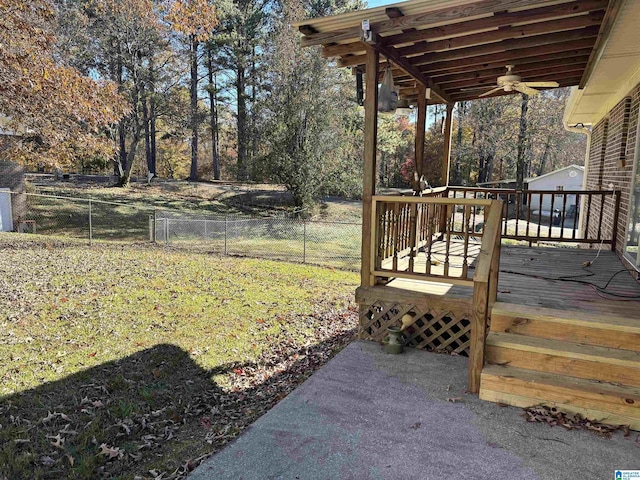 view of yard with ceiling fan and a wooden deck