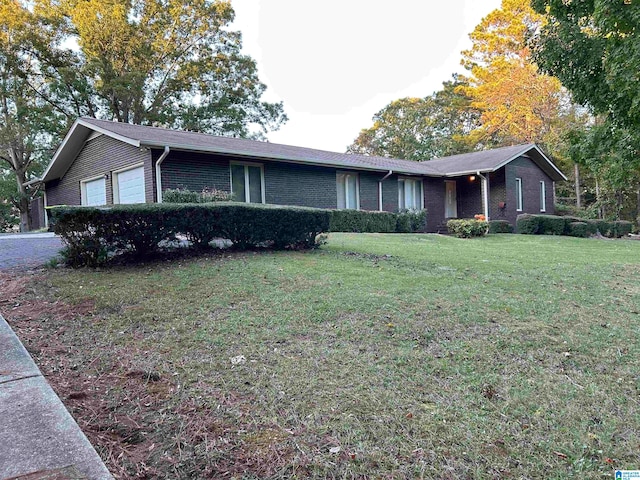 ranch-style home featuring a front yard