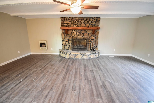 unfurnished living room featuring hardwood / wood-style flooring, beamed ceiling, heating unit, a fireplace, and ceiling fan