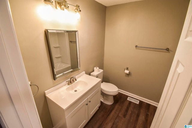 bathroom featuring toilet, hardwood / wood-style floors, and vanity