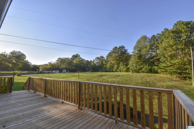 wooden terrace featuring a yard