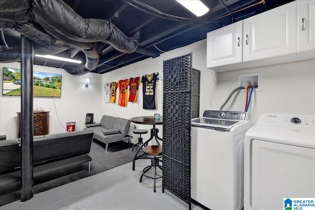 washroom featuring separate washer and dryer and cabinets