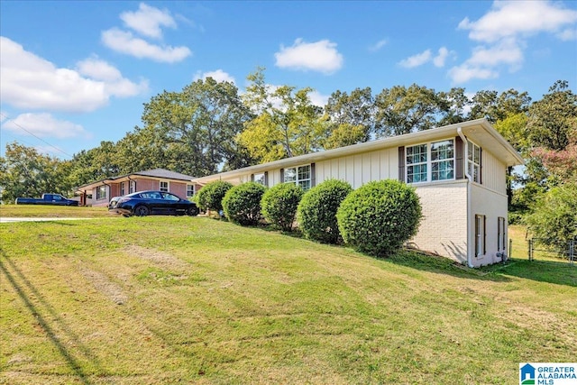 view of side of property with a lawn