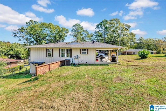 view of front of house with central AC, a front yard, and a patio area