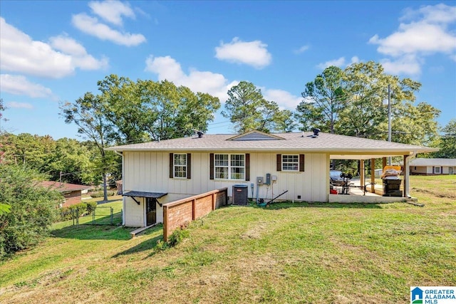 back of house featuring a patio, a lawn, and central AC unit