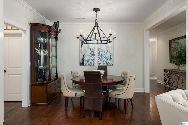 dining room featuring a notable chandelier, ornamental molding, and dark wood-type flooring