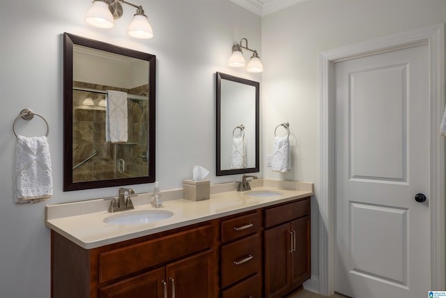 bathroom with vanity, crown molding, and a shower with shower door