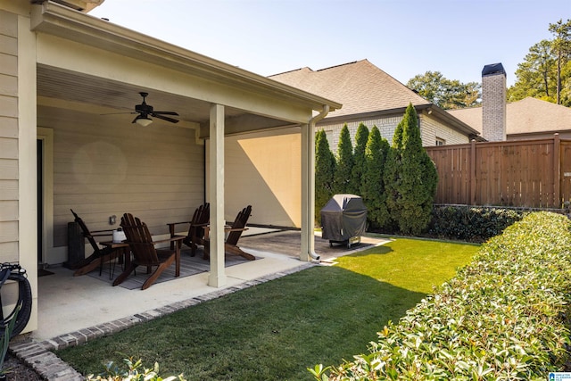 view of yard featuring a patio area and ceiling fan