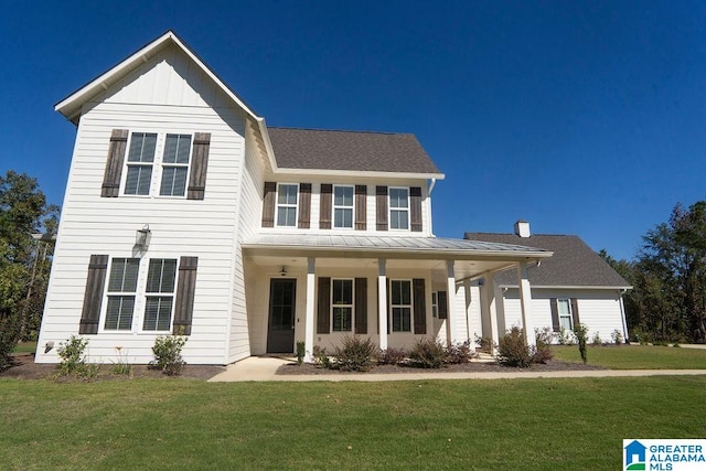 view of front of property with covered porch and a front yard