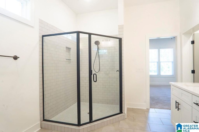 bathroom with vanity, walk in shower, and tile patterned floors