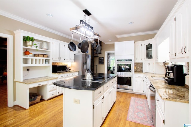 kitchen featuring a kitchen island, white cabinetry, stainless steel appliances, and light wood-type flooring