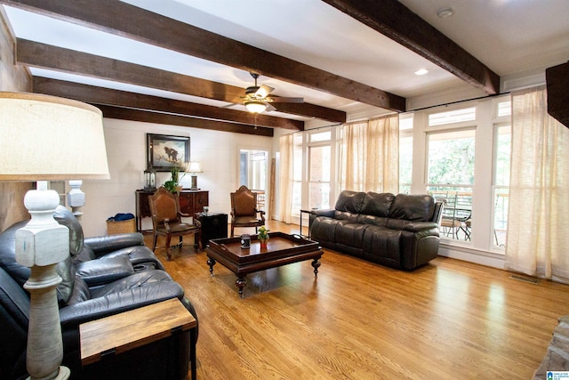 living room with beam ceiling, light hardwood / wood-style floors, a healthy amount of sunlight, and ceiling fan