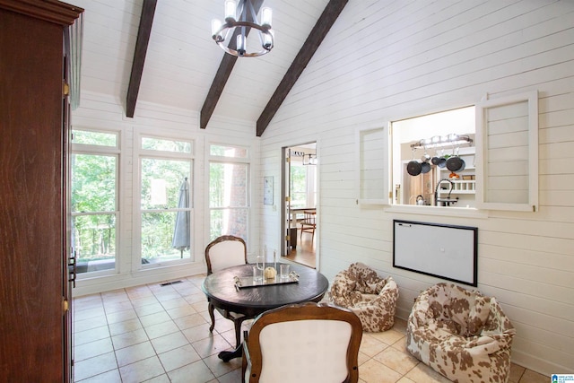 sunroom / solarium with a notable chandelier and vaulted ceiling with beams