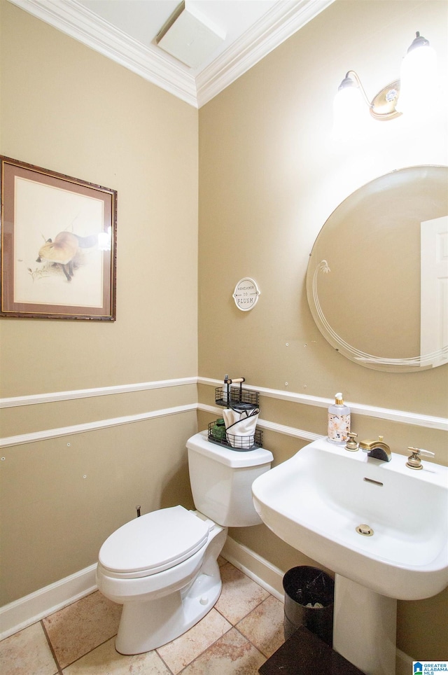 bathroom featuring toilet, crown molding, sink, and tile patterned floors