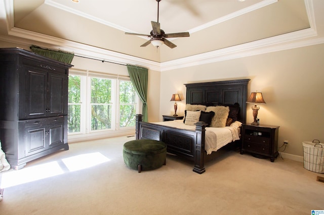 carpeted bedroom featuring crown molding, a raised ceiling, and ceiling fan