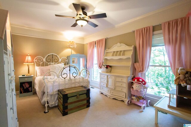 carpeted bedroom with ceiling fan and crown molding