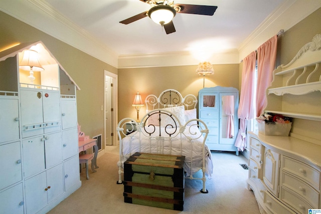 carpeted bedroom with ceiling fan and ornamental molding