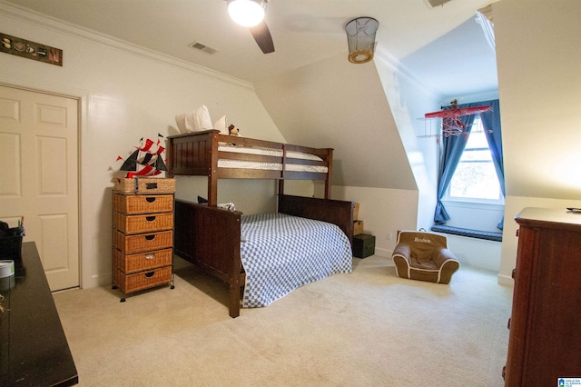 carpeted bedroom with lofted ceiling, ornamental molding, and ceiling fan