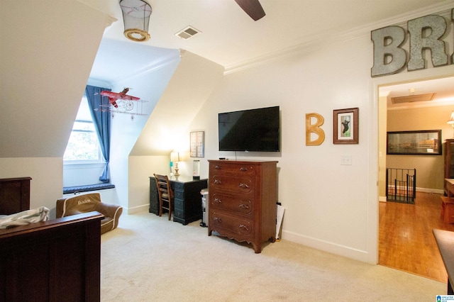 bedroom with ornamental molding and light colored carpet