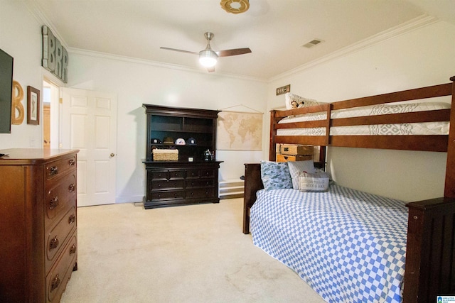 bedroom featuring crown molding, light colored carpet, and ceiling fan