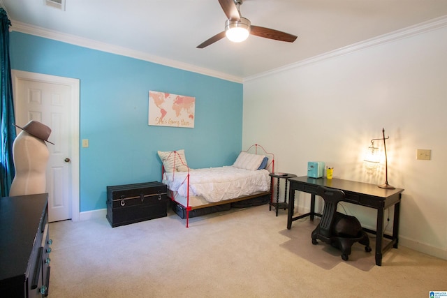 carpeted bedroom with ornamental molding and ceiling fan