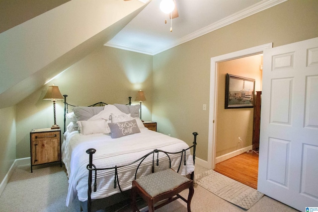 bedroom with ornamental molding, vaulted ceiling, light hardwood / wood-style floors, and ceiling fan