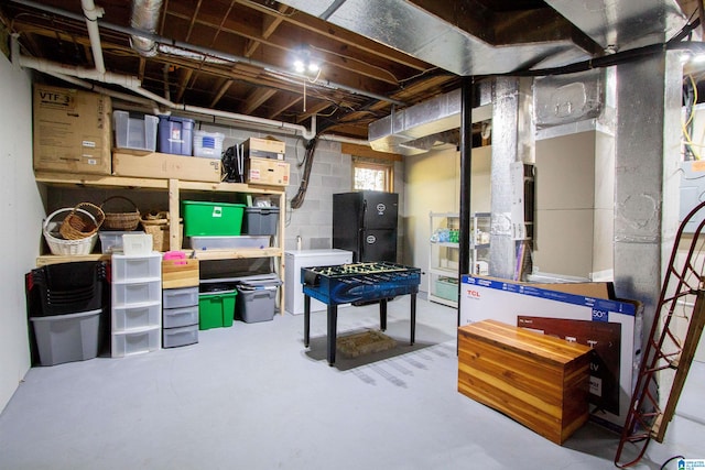 basement with black fridge