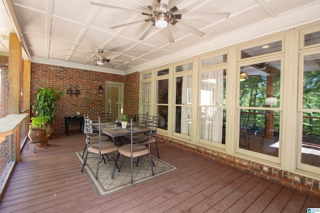 sunroom / solarium with a healthy amount of sunlight, ceiling fan, and coffered ceiling