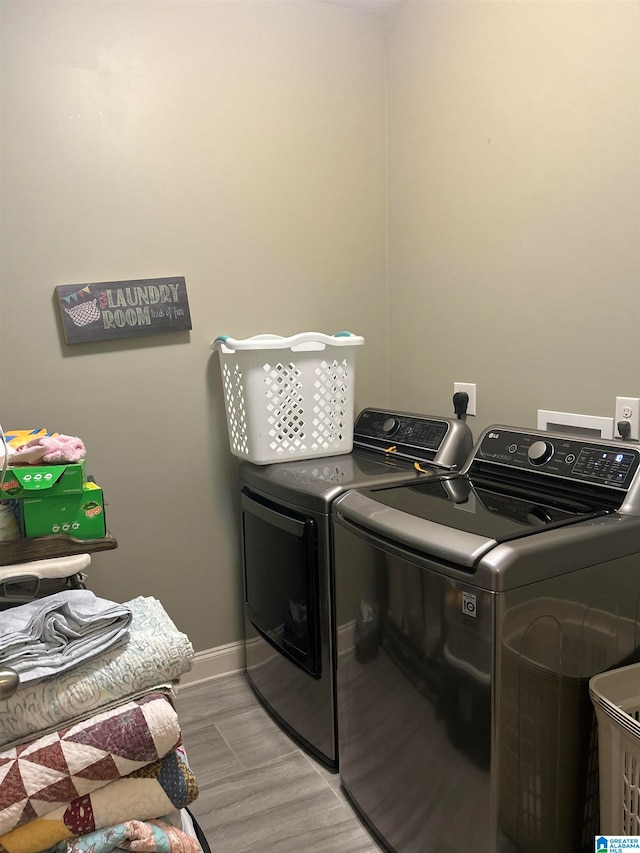 washroom featuring washer and clothes dryer and light wood-type flooring