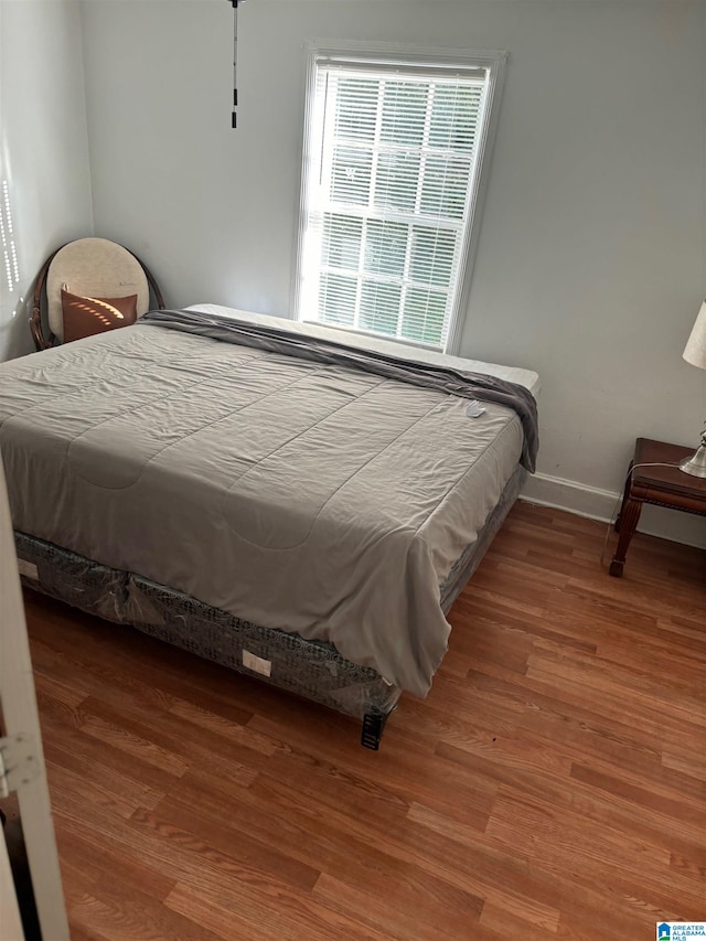 bedroom with hardwood / wood-style floors