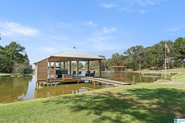 dock area with a water view and a yard