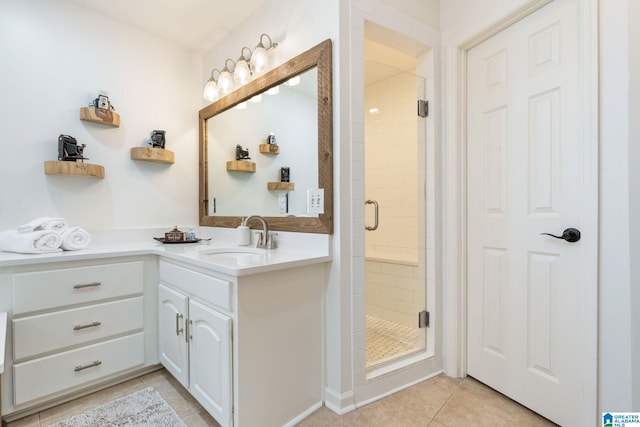 bathroom with an enclosed shower, vanity, and tile patterned floors