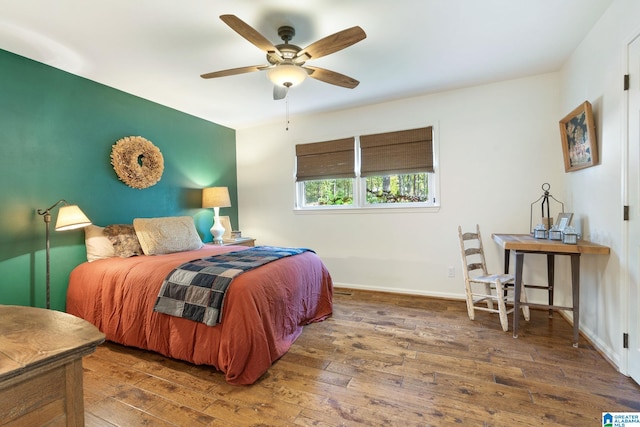 bedroom featuring dark hardwood / wood-style flooring and ceiling fan