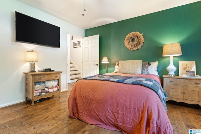 bedroom with hardwood / wood-style flooring