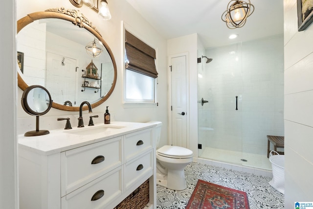 bathroom featuring toilet, vanity, tile patterned flooring, and walk in shower