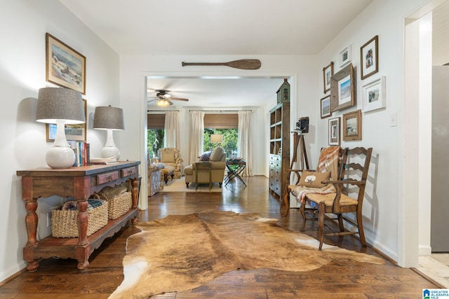 sitting room with hardwood / wood-style flooring and ceiling fan