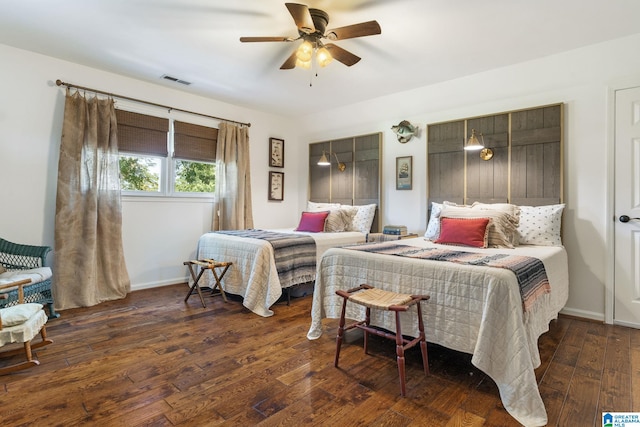 bedroom with dark hardwood / wood-style flooring and ceiling fan