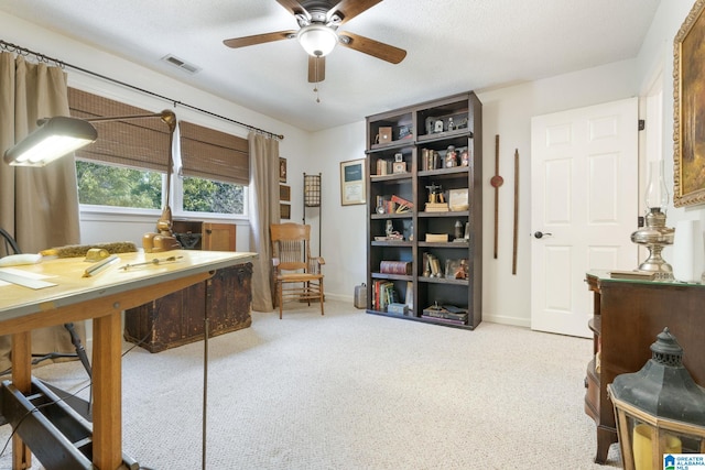 office with ceiling fan, a textured ceiling, and light carpet