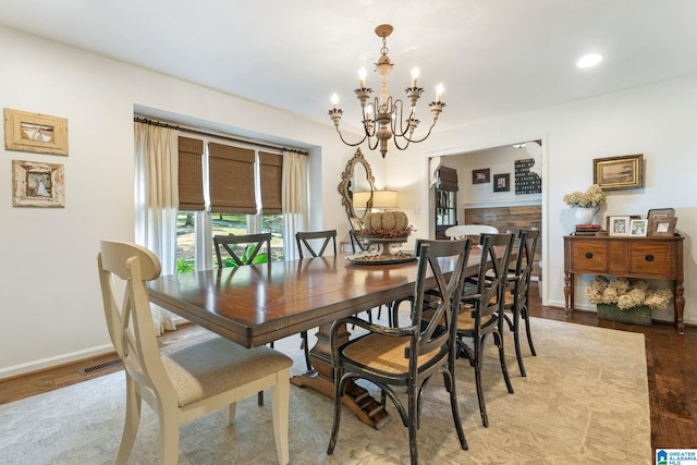 dining room with an inviting chandelier and light hardwood / wood-style flooring