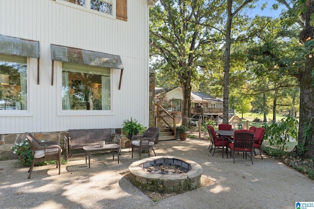 view of patio with a wooden deck and a fire pit