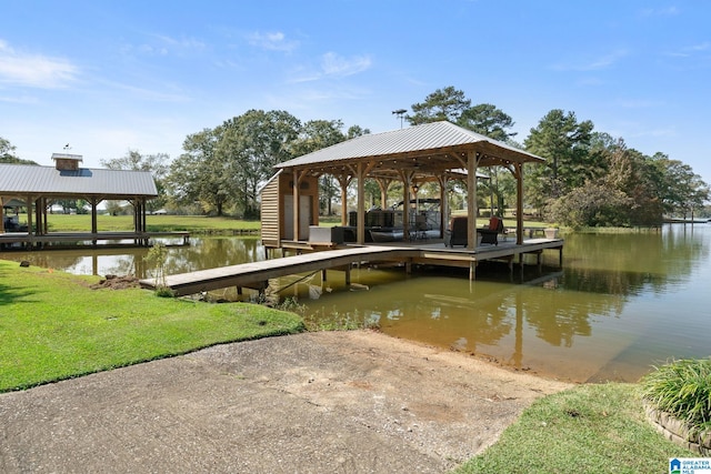 view of dock featuring a water view, a yard, and a gazebo