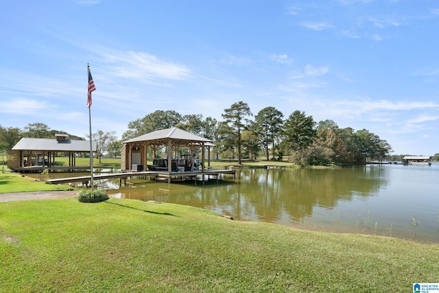 dock area with a water view and a lawn