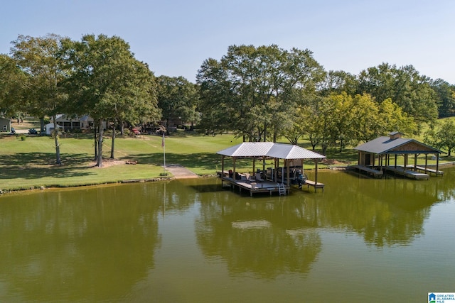 view of dock with a lawn and a water view