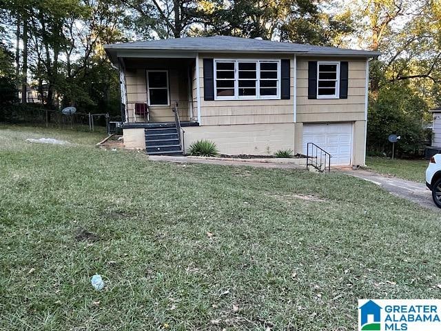 view of front of property with a garage and a front lawn