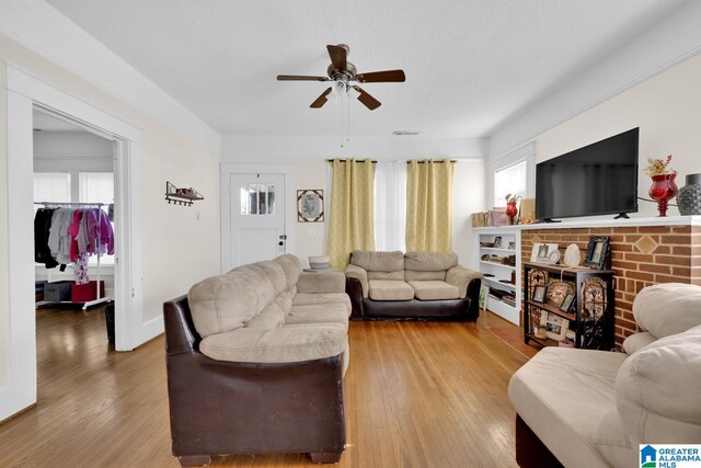 living room with hardwood / wood-style floors and ceiling fan