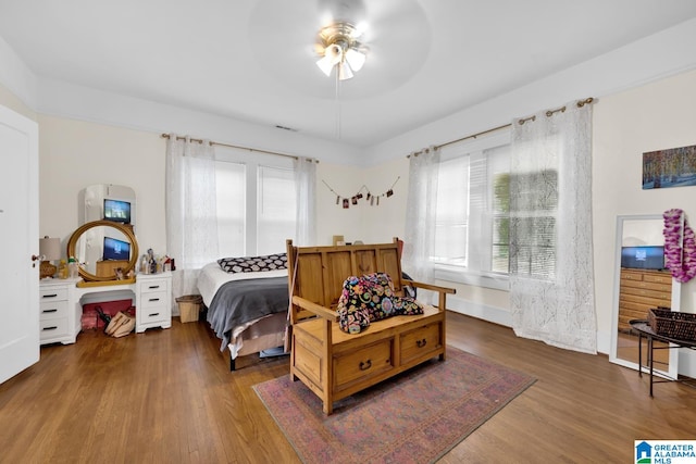 bedroom with ceiling fan and dark hardwood / wood-style flooring